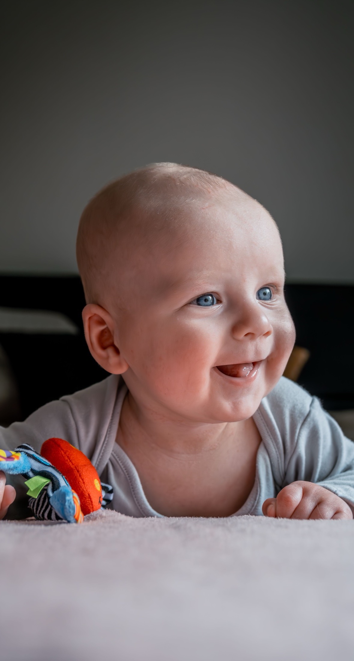 A smiling baby at crawling age