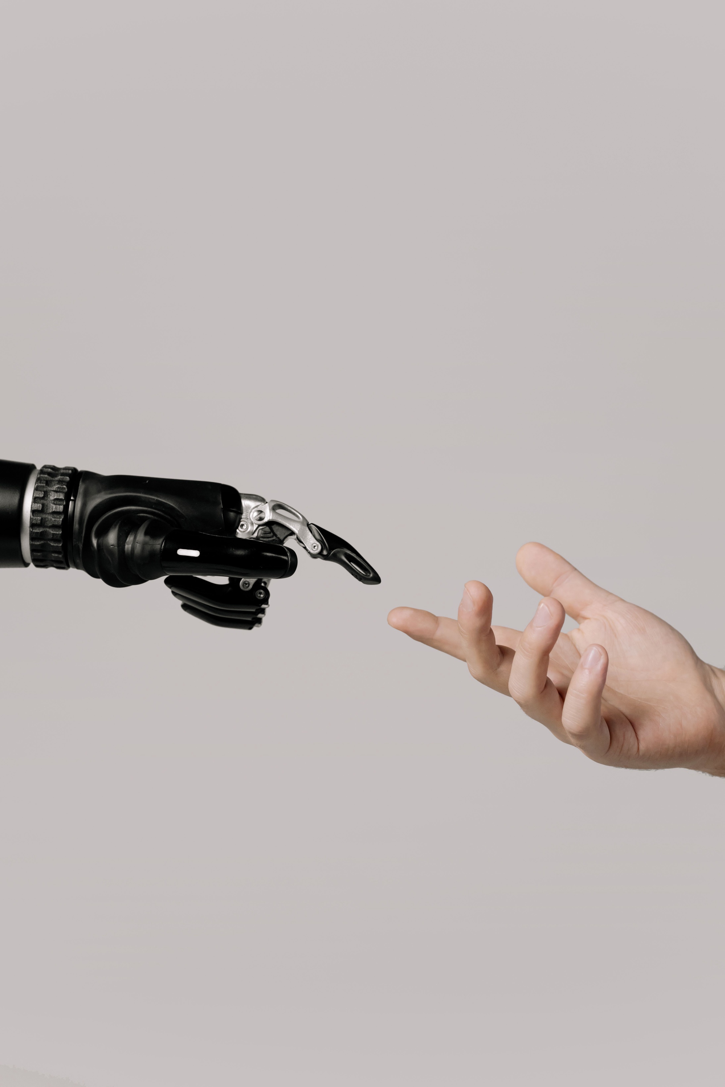 A moment of touch between a reaching robotic hand and a human hand